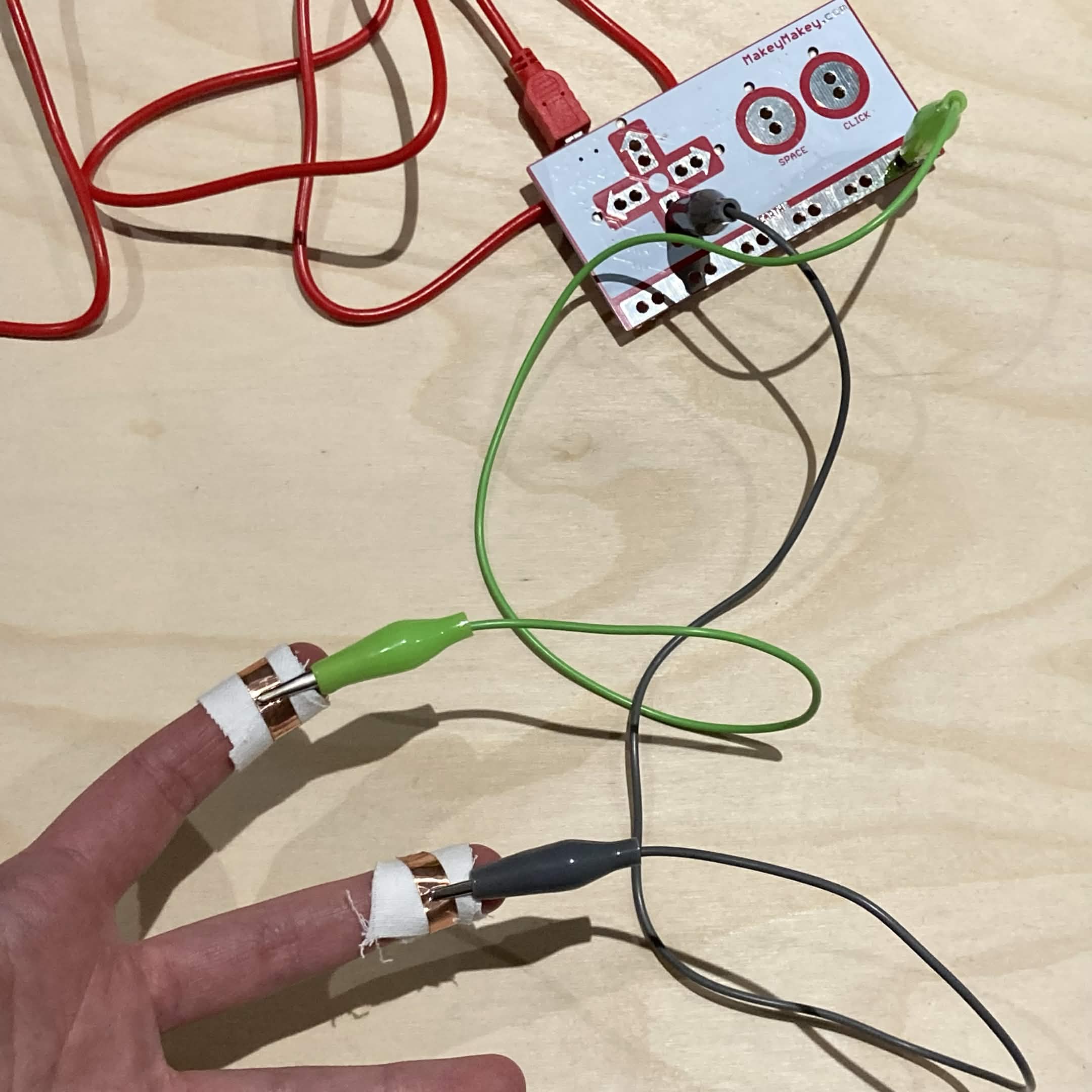 The wearable finger circuits connected to the Makey Makey alligator clips